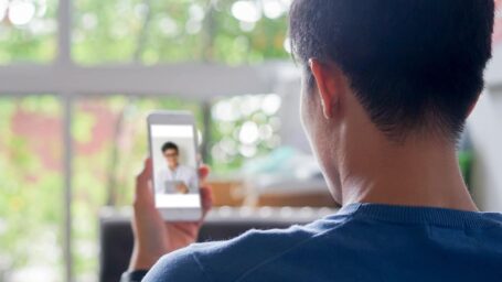Man using smartphone to video conference